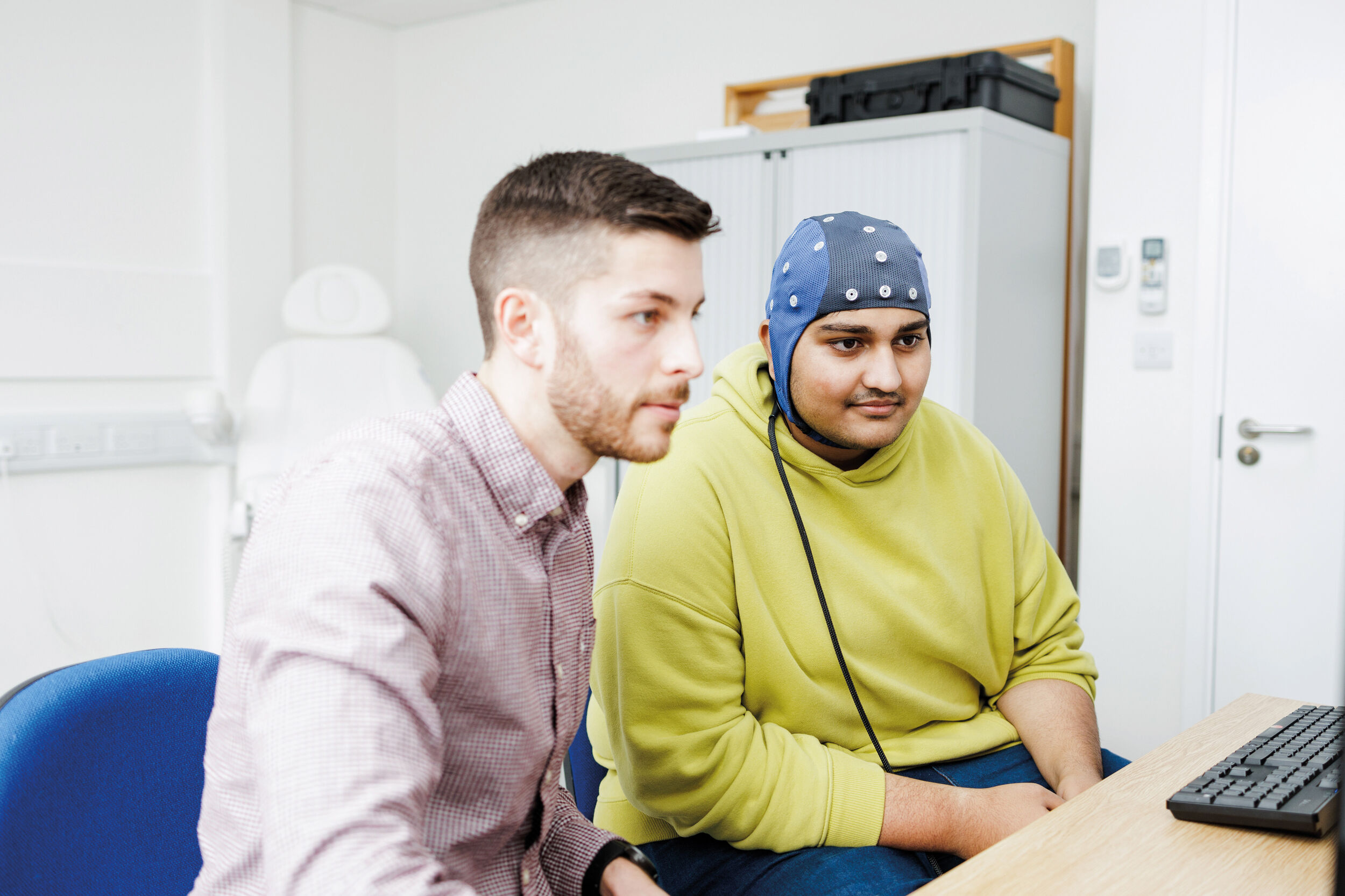 A student and researcher conduct experiments in Kent's EEG lab.