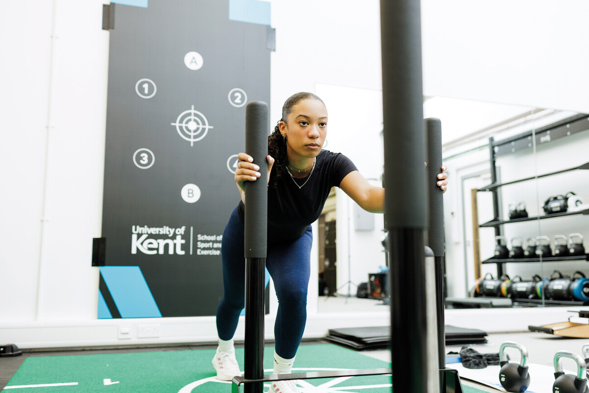 A University of Kent student using equipment in the strength and conditioning lab.