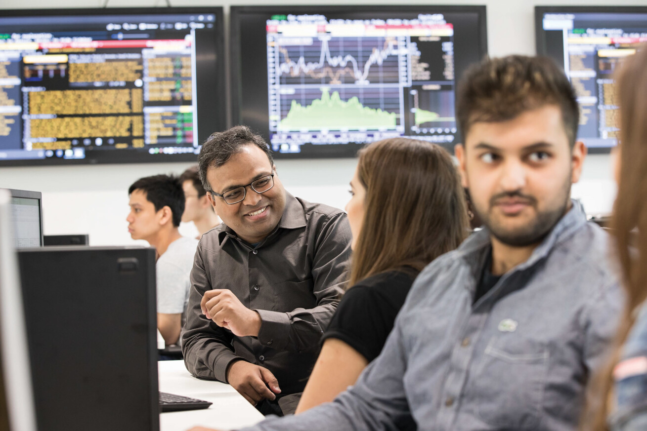 Kent student analyse data on PC screens.