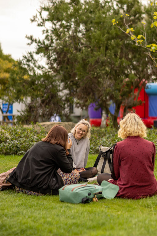 Kent students chatting on the grass.