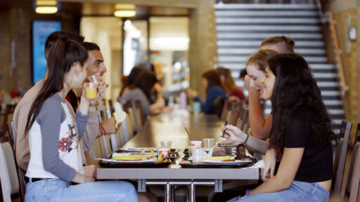 Rutherford Dining Hall at the University of Kent. Students sitting at a table eating lunch