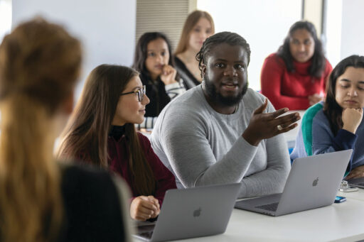 Groups of Kent students debating in class.