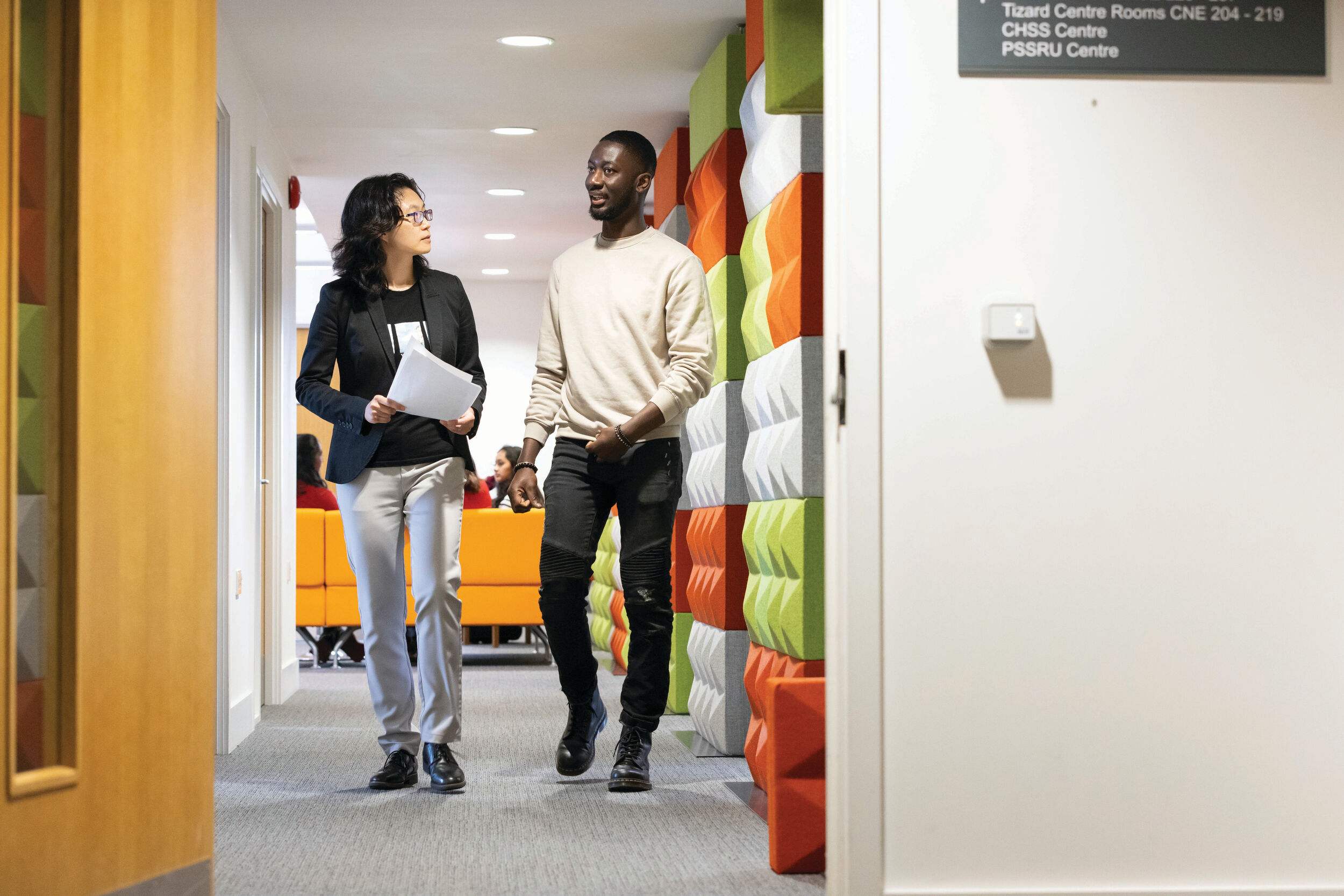 A student and academic in discussion.