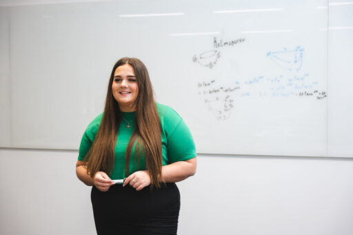 A Kent Actuarial Science student at a white board.